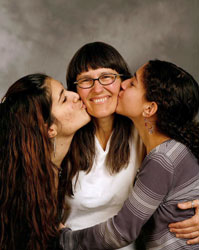 Daughters kissing mom